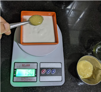 adding fenugreek paste to idli batter sample